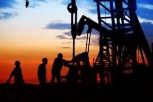 Oil workers at night