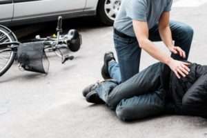 Driver with hurt bike rider