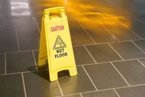 Wet floor sign on dark floor