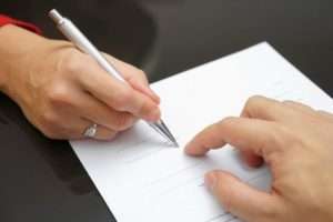People signing document