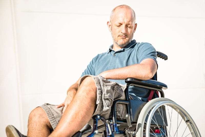 Man looking down in wheelchair