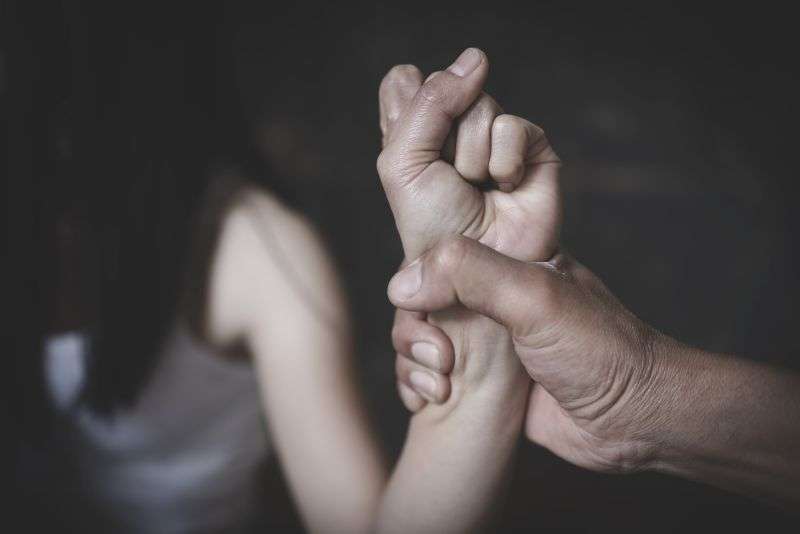 man grabbing woman's arm